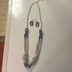 Silver necklace with matching earrings.